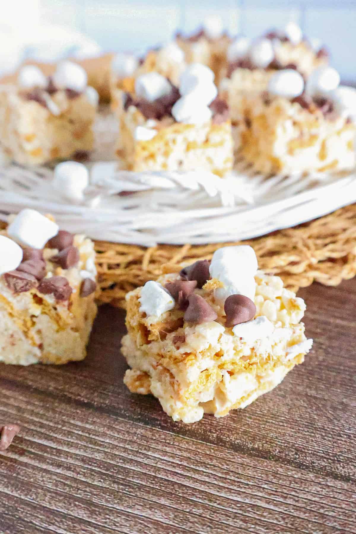 Close-up of a homemade S'mores Rice Krispie treat topped with chocolate chips and mini marshmallows.