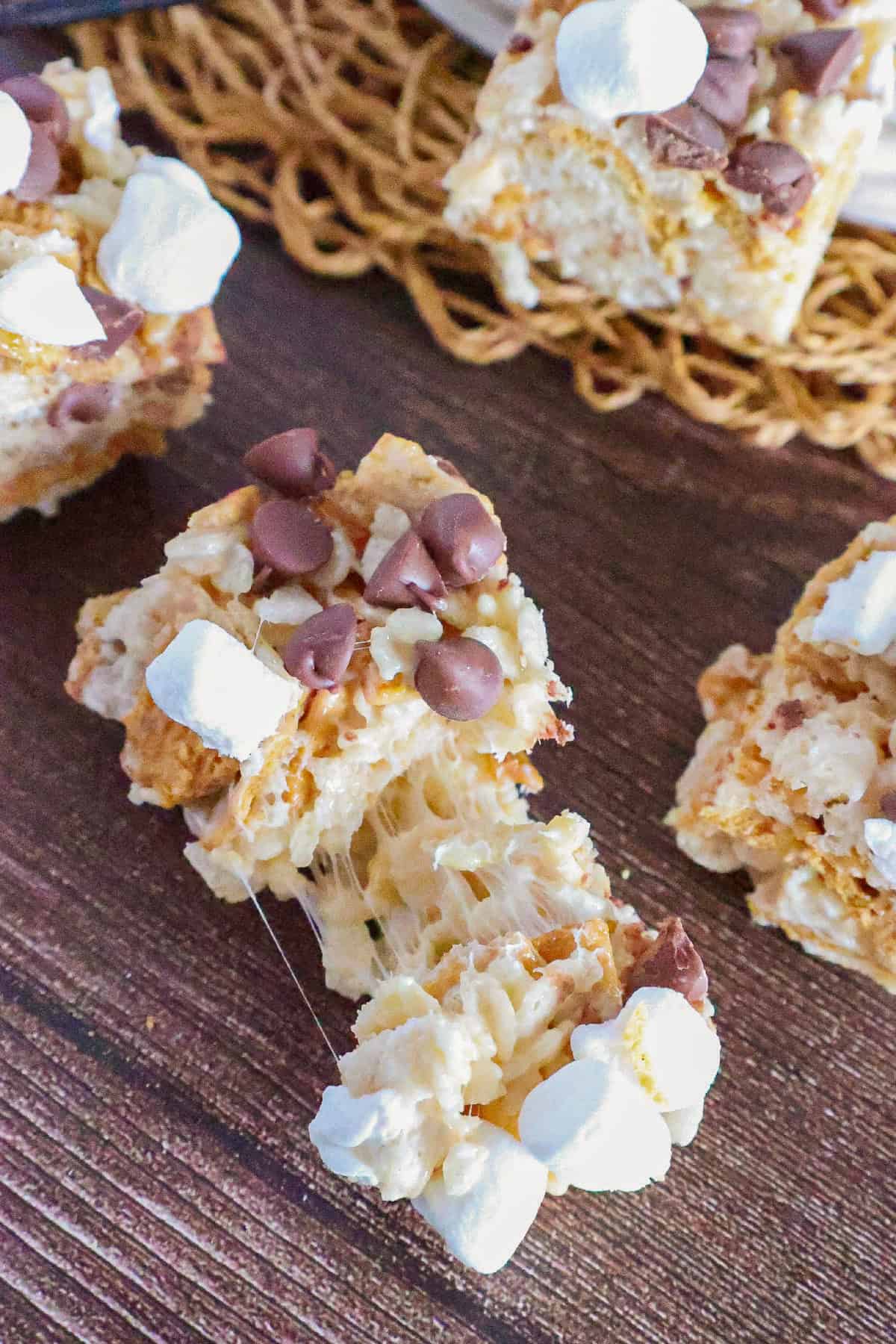 Gooey S'mores Rice Krispie treats with melted marshmallow, chocolate chips, and graham cracker pieces.