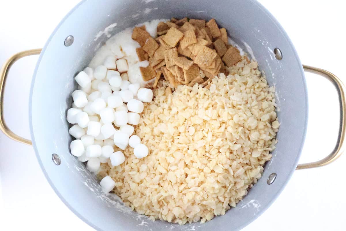 Rice Krispies cereal, Golden Grahams, and marshmallows added to the melted marshmallow mixture.