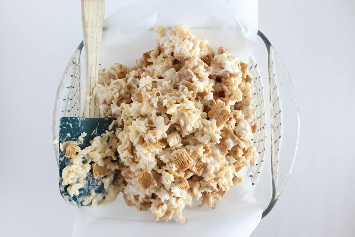 S'mores Rice Krispie treat mixture transferred to a parchment-lined baking dish.