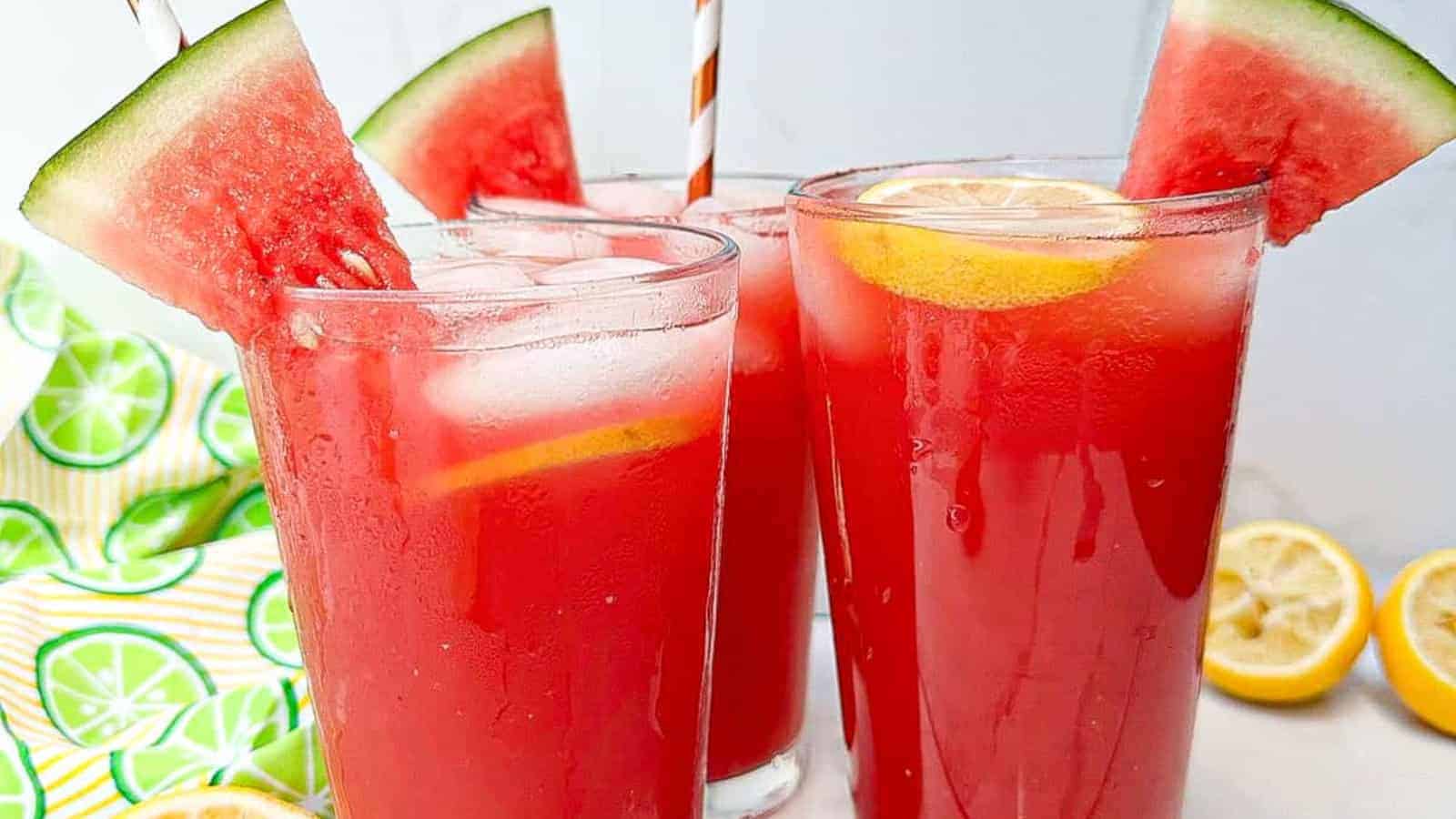 Watermelon juice in glasses with watermelon wedges and lemon slices.