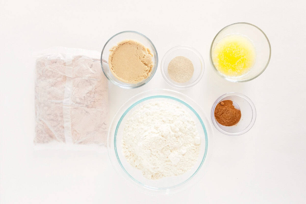 Ingredients for red velvet cinnamon rolls including cake mix, flour, yeast, brown sugar, cinnamon, and melted butter.