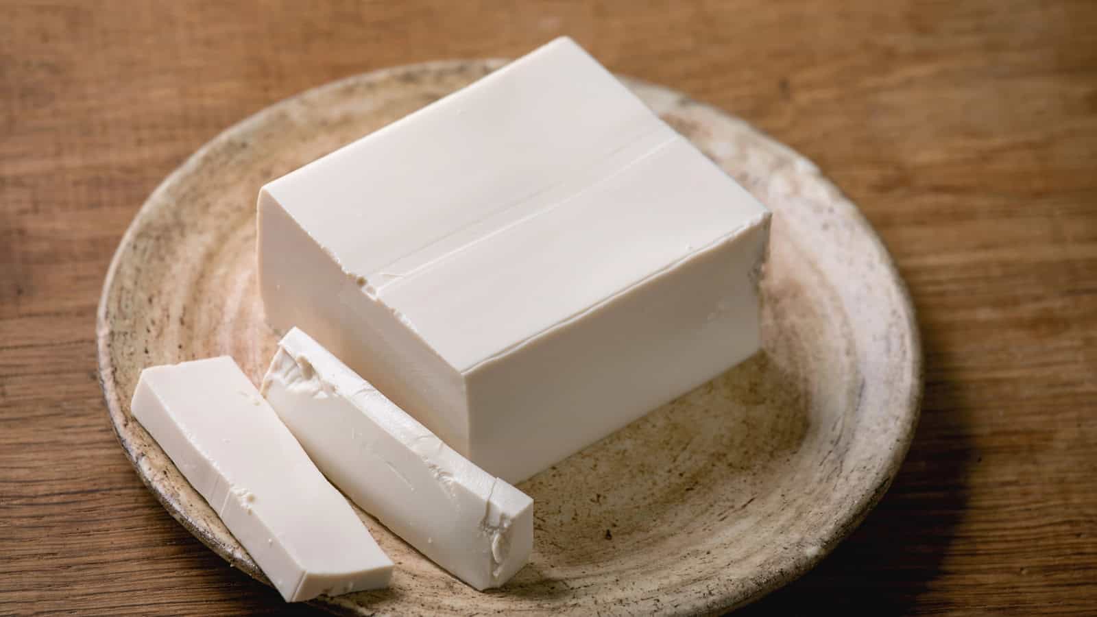 Block of tofu on a ceramic plate.