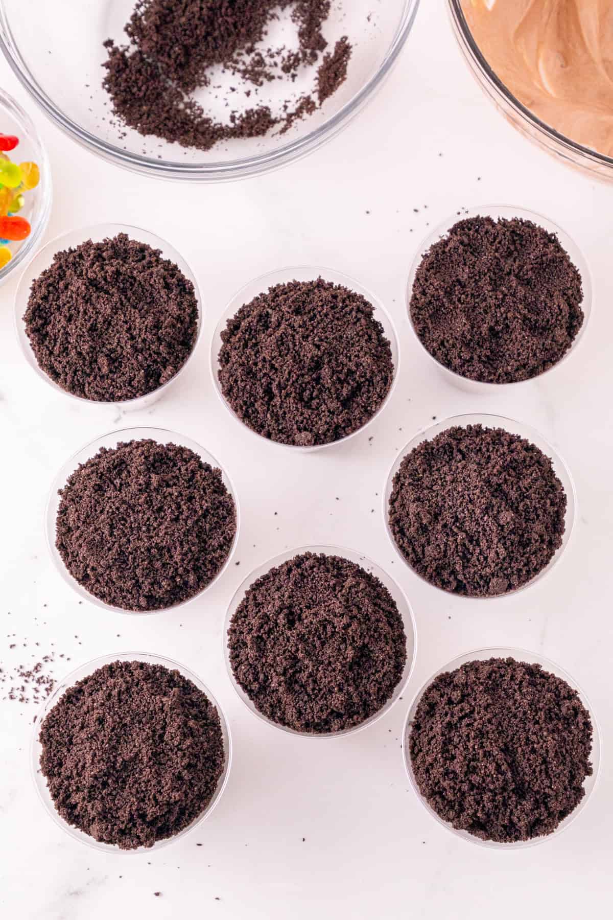Chocolate pudding cups topped with a layer of crushed Oreo cookie crumbs.