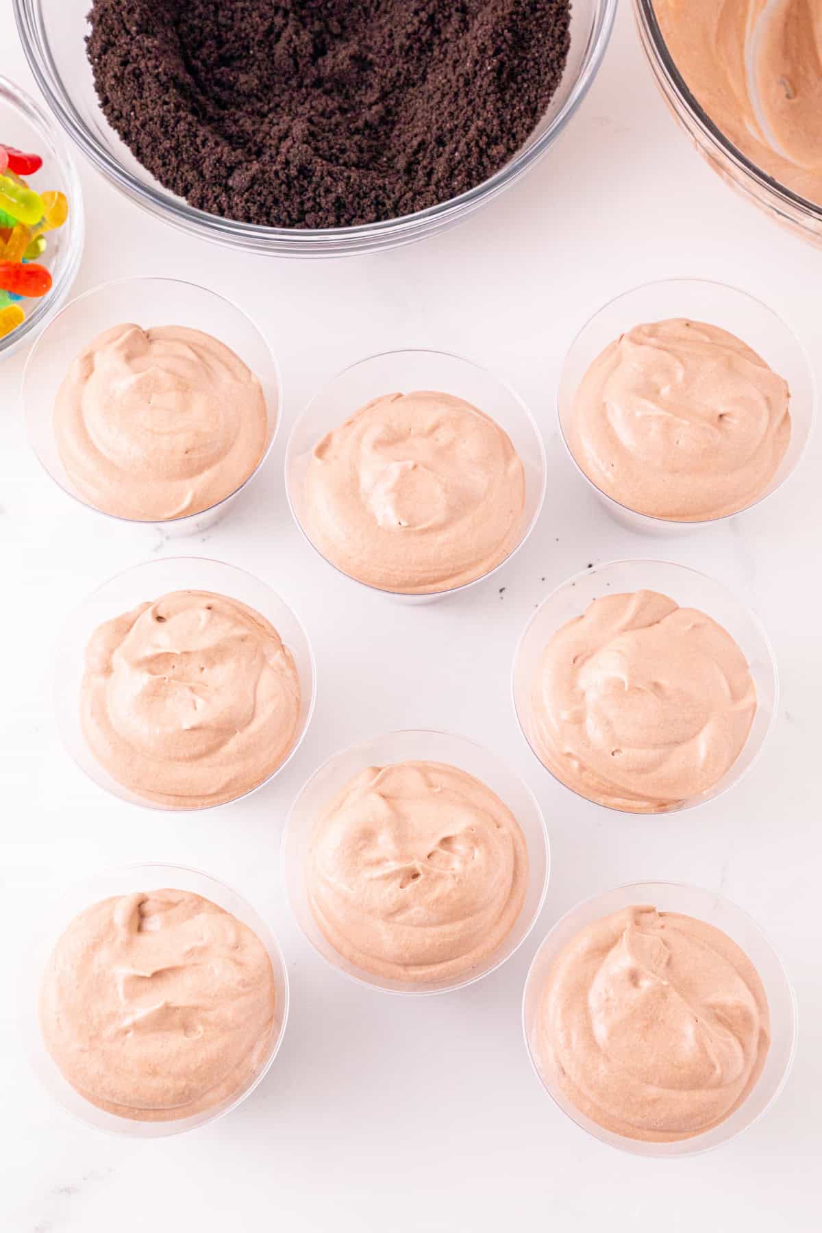 Chocolate pudding mixture layered over Oreo crumbs in individual dessert cups.